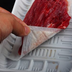 cooked meat with absorbent pad